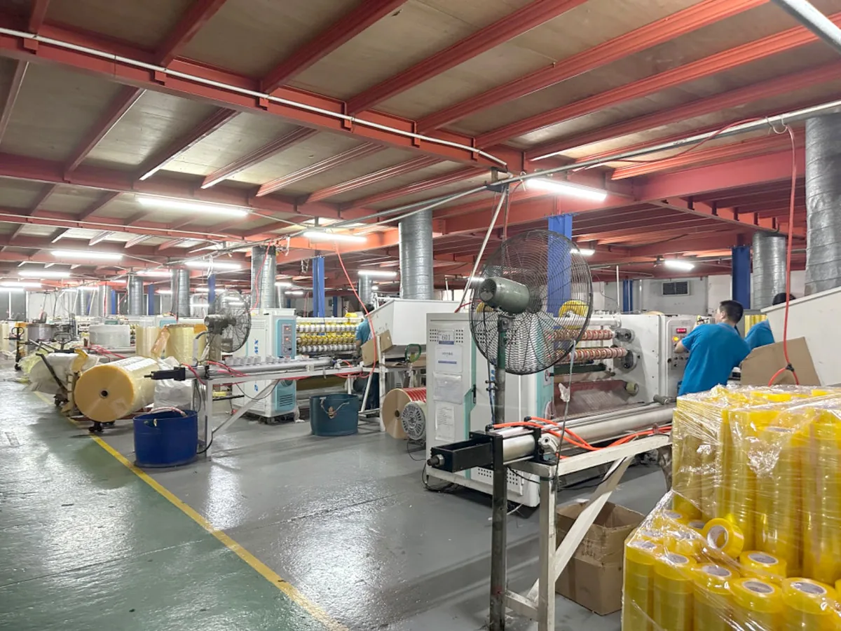 Tape slitting machines with jumbo tape rolls